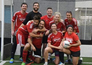 Soccer team in red uniforms posing for a team picture