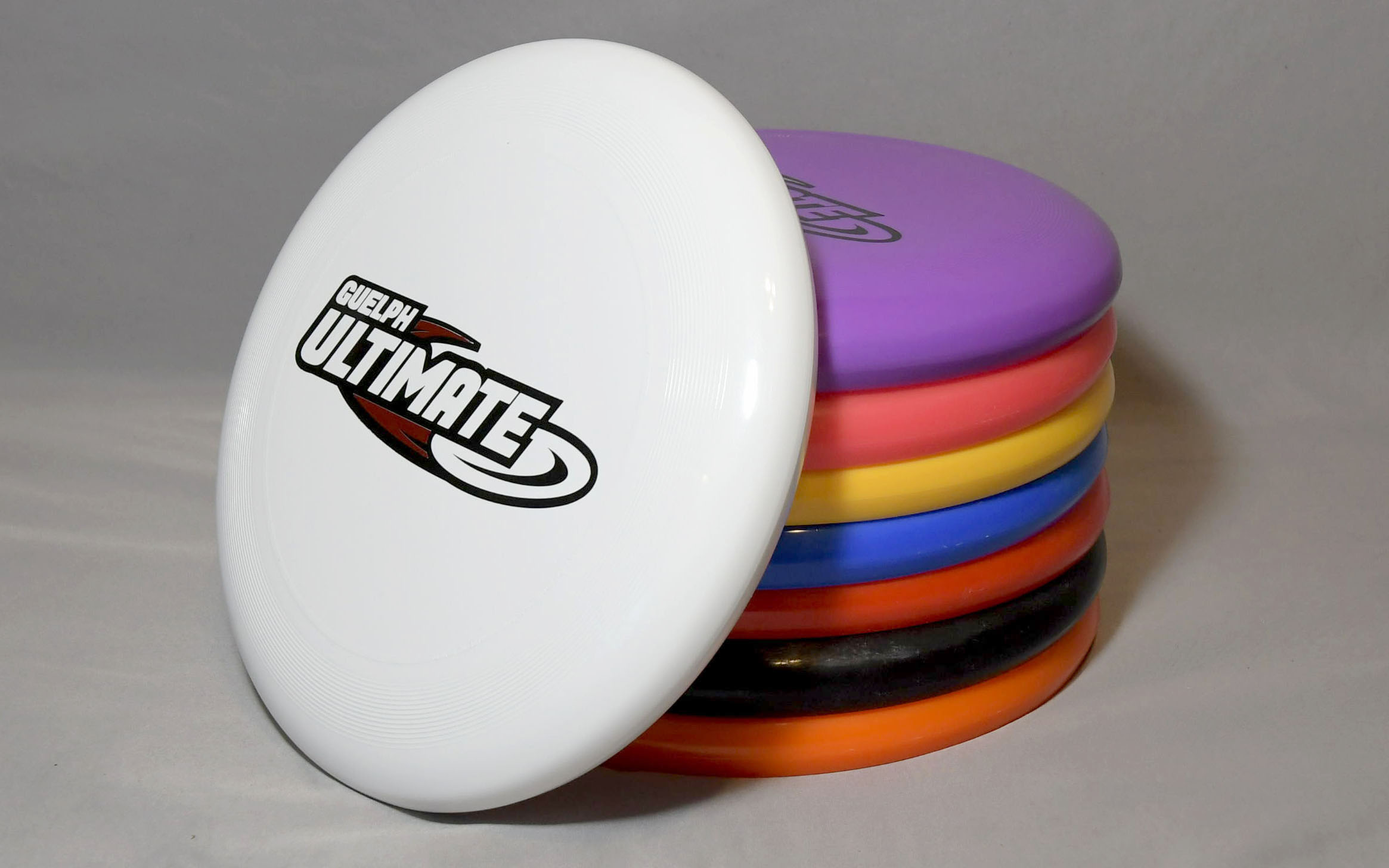 white, purple, orange, yellow, blue, red, black and orange frisbees