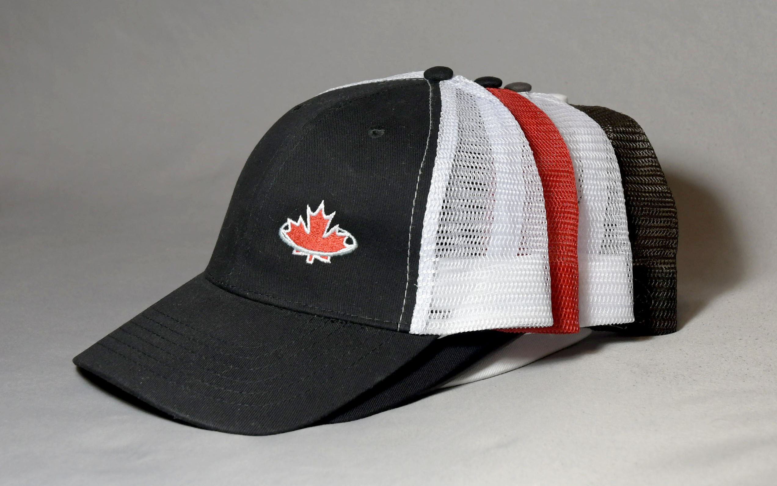 Black, white, red and brown trucker hats